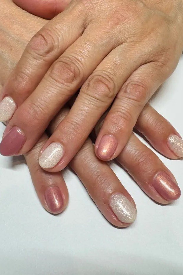 Sheer mauve nails, darker mature hands