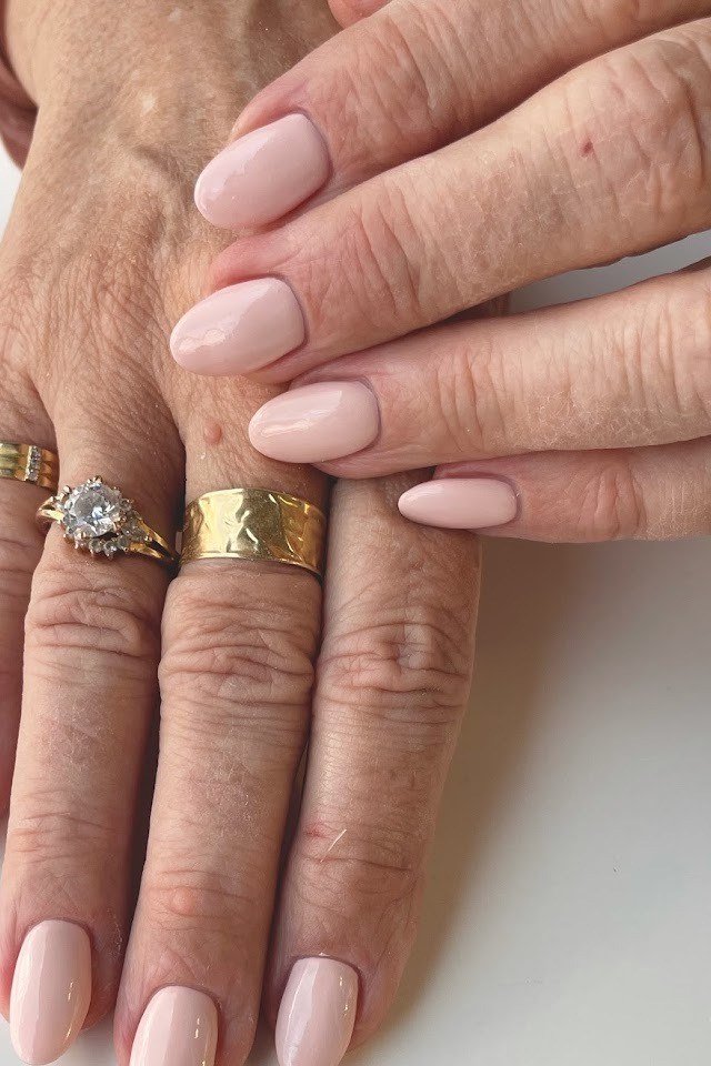 Nude Pink Long Oval With Gold Rings - nail color idea for women over 60