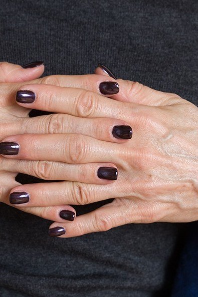 Dark wine nails, older hands