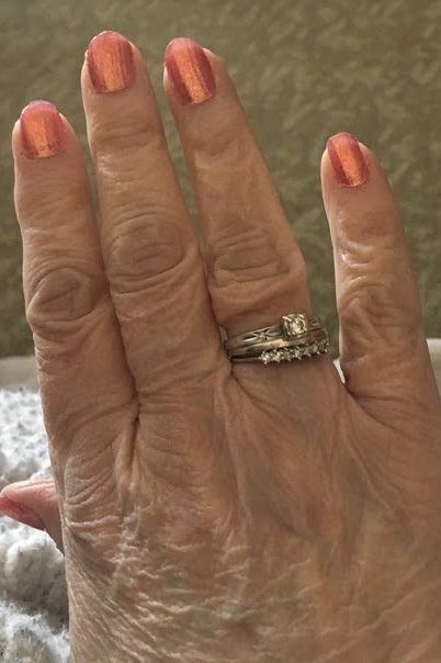 Peach shimmer nails, very mature wrinkled hands