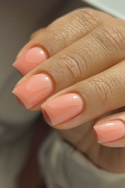 Soft peach nails, middle-aged hand