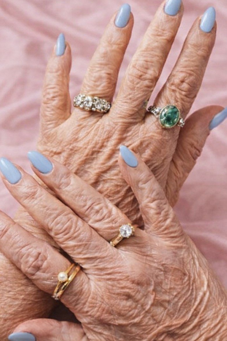 Pale blue nails, very old hands on pink silk