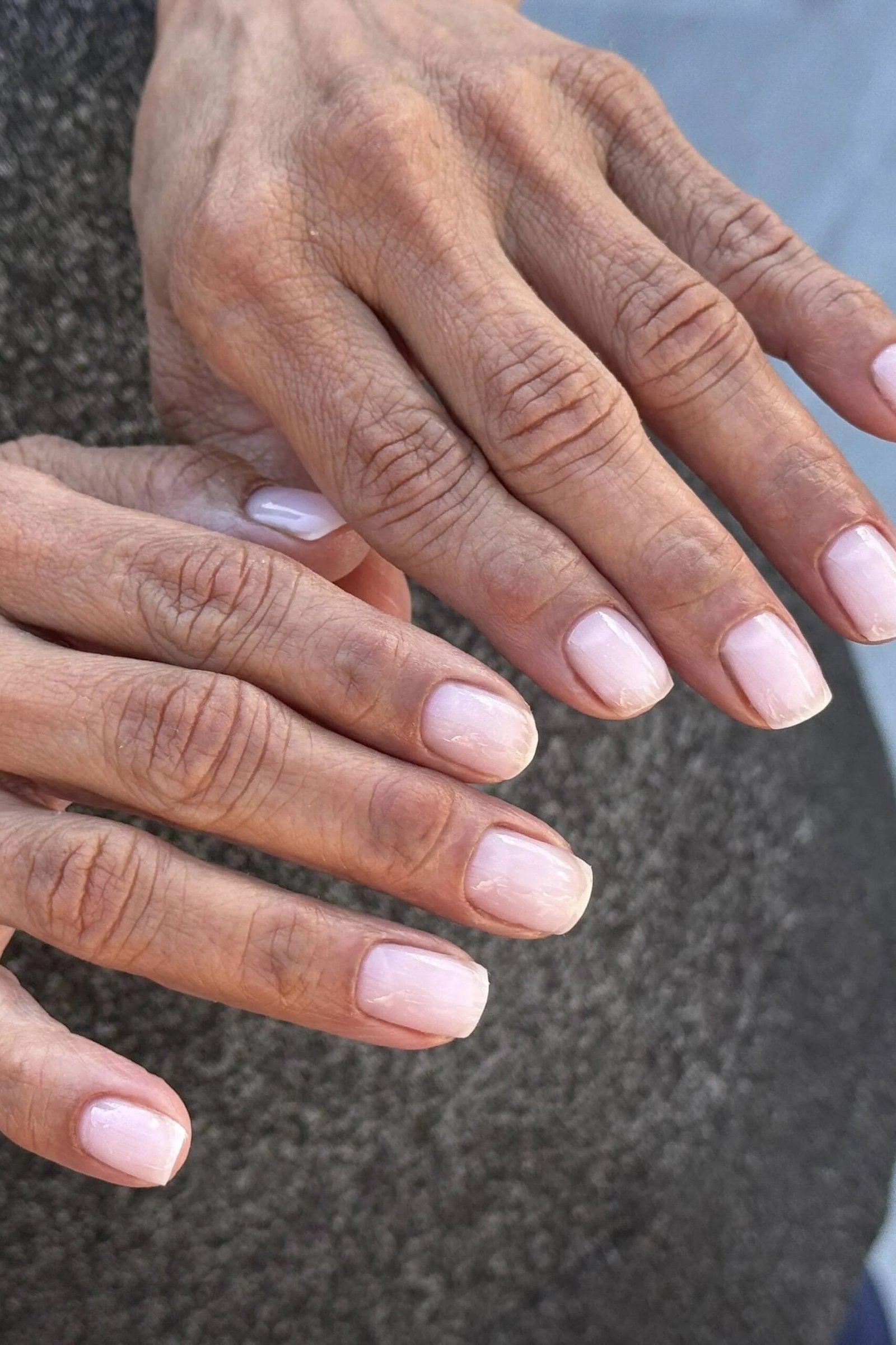 Baby pink round nails, mature hands