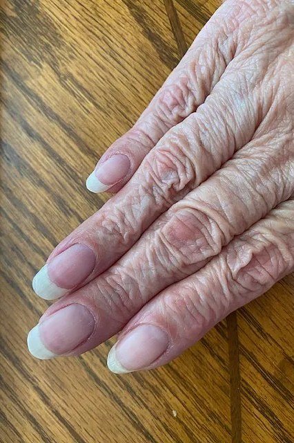 White french square nails, elderly hands with rings
