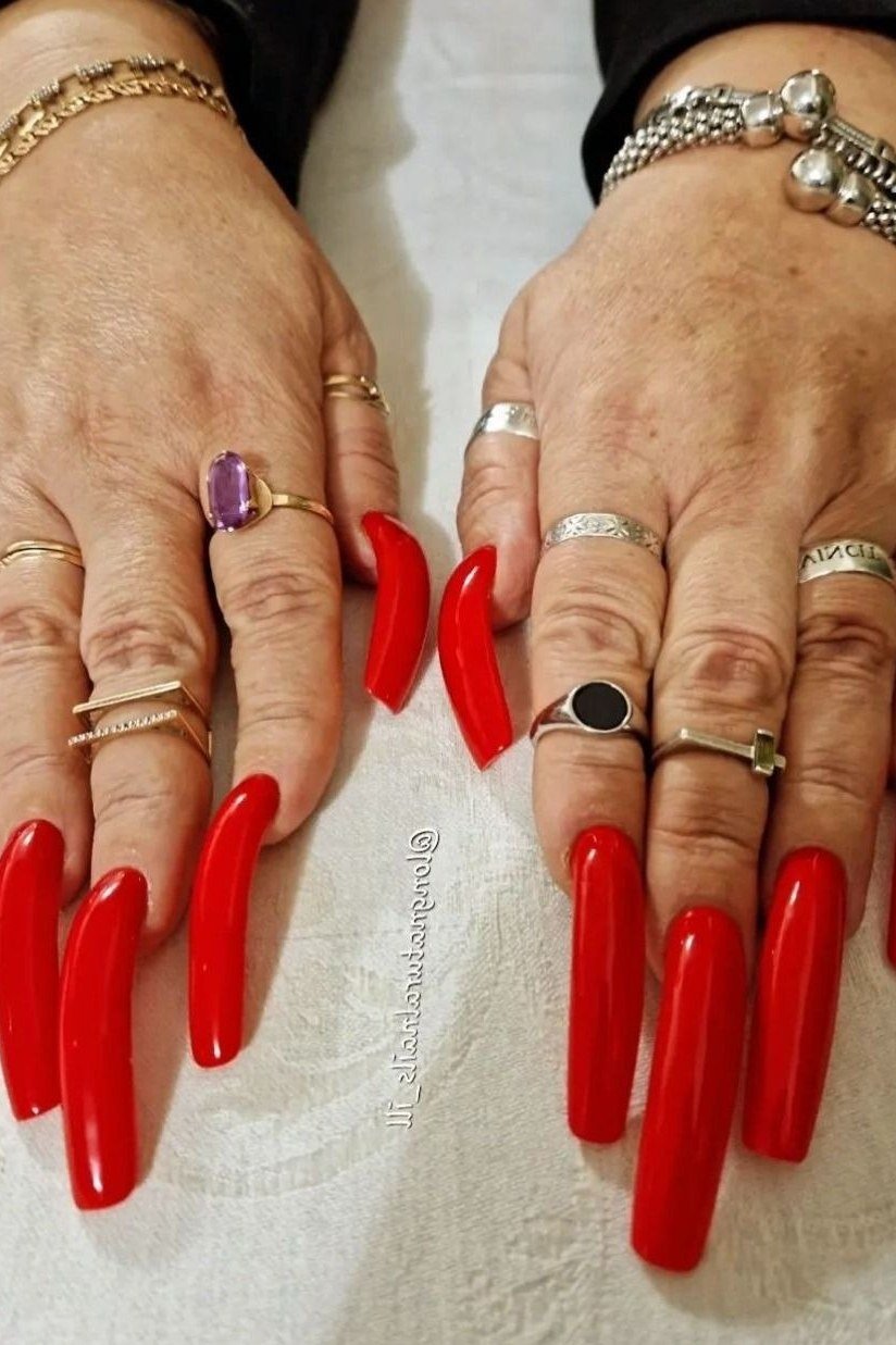 Red stiletto nails, mature hands with bracelets