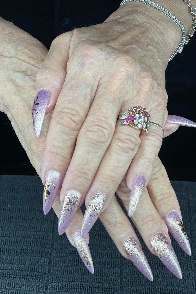 Glitter stiletto nails, elderly hands