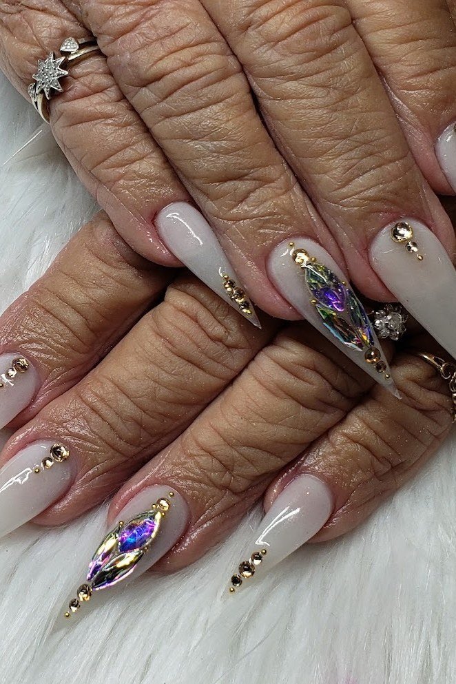 Crystal-accented stiletto nails, elderly hands