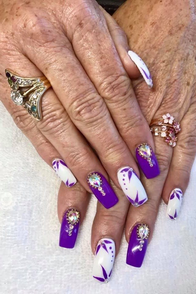 Purple coffin nails with floral art, elderly hands