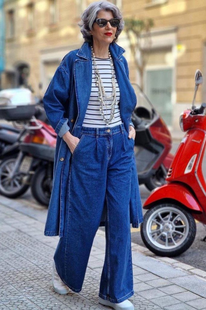 Blue denim coat over striped top with wide-leg jeans, timeless outfit idea for women over 60