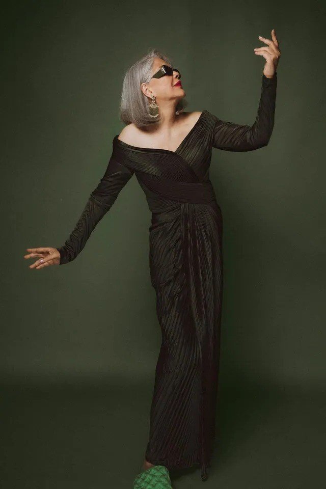 Dark green pleated jumpsuit, elegant one-piece outfit idea for women over 60