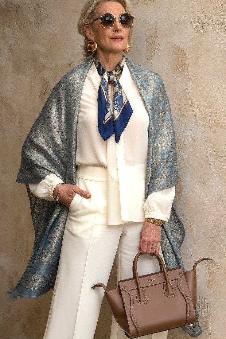 Cream blouse with white trousers, scarf and tan bag, monochrome outfit for women over 60