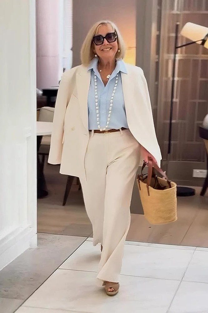 Cream blazer with light blue shirt and cream trousers, polished day outfit for women over 60