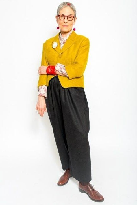 Mustard yellow blazer with black wide trousers, bold color outfit for women over 60