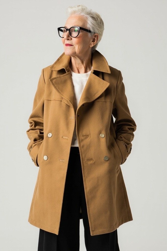 Camel trench coat with dark trousers, timeless fall outfit for women over 60