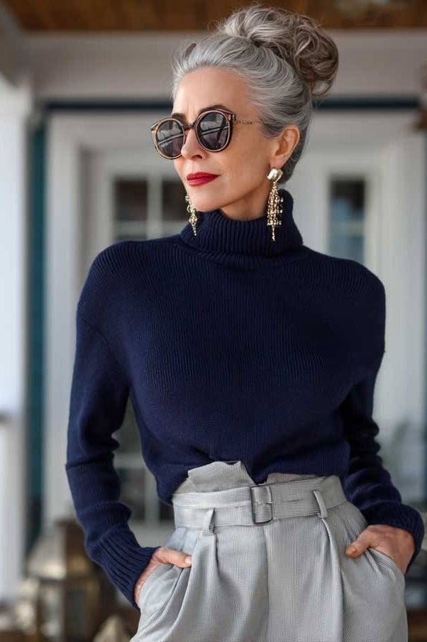 Effortlessly polished outfit for women over 50: A navy turtleneck and gray wide-leg trousers, gray tote