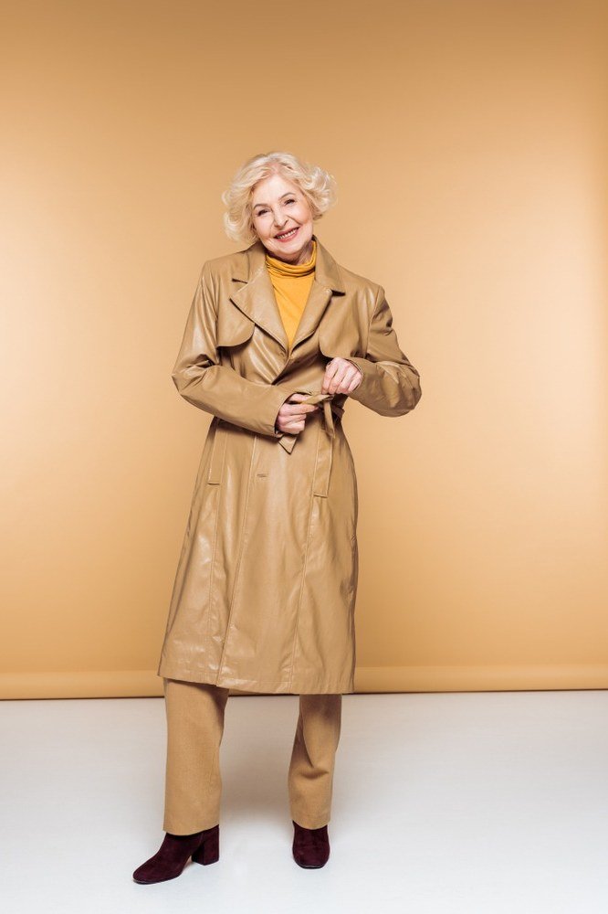 october outfits for women over 60: tan leather trench mustard turtleneck