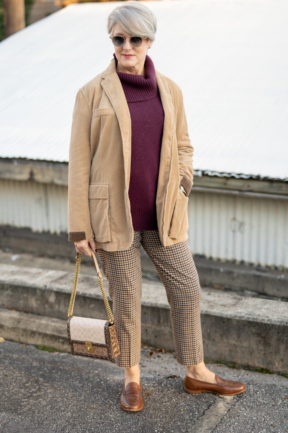 october outfits for women over 60: camel coat plum turtleneck houndstooth trousers