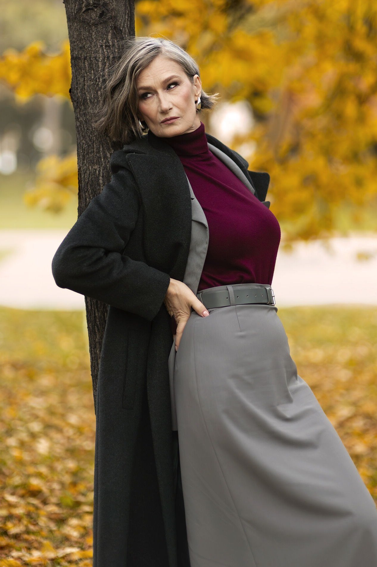 october outfits for women over 60: black coat burgundy turtleneck gray midi skirt