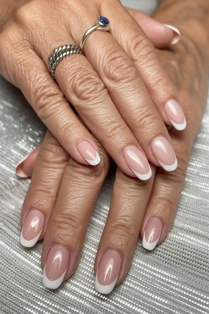 Old money nude almond french with gold rings manicure for women over 60