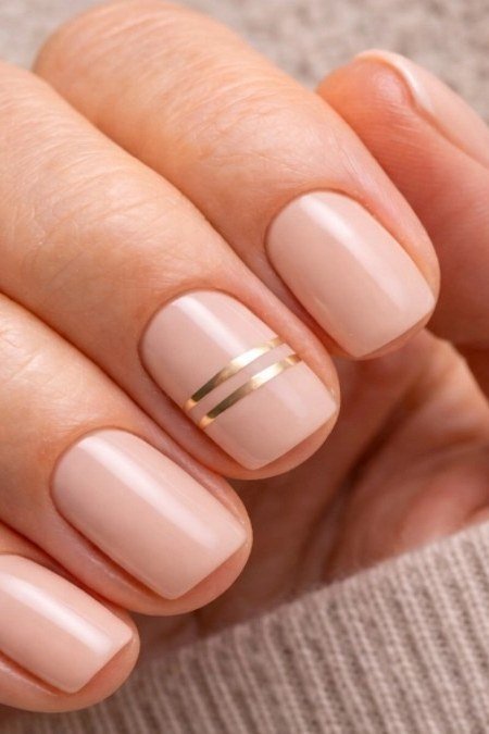Old money nude nails with a delicate gold line manicure for women over 60