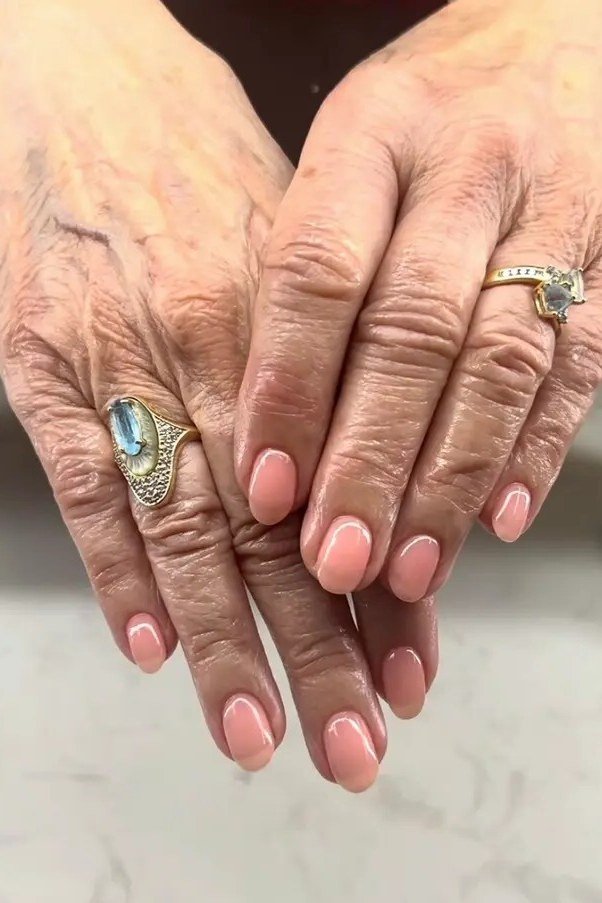 Old money soft coral short nails manicure for women over 60