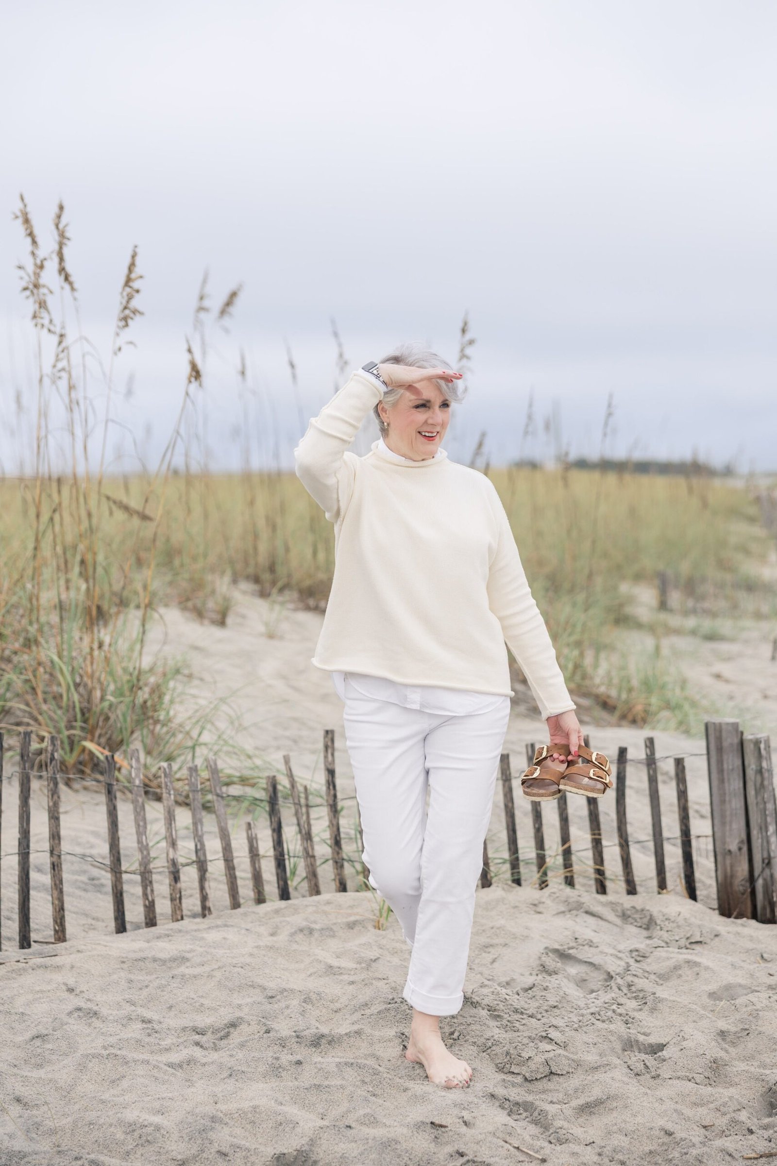 Trendy outfit for women over 70: all-white outfit on beach
