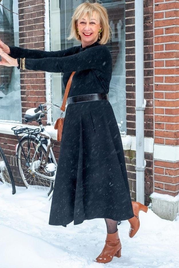 Trendy outfit for women over 70: black coat dress + brown boots