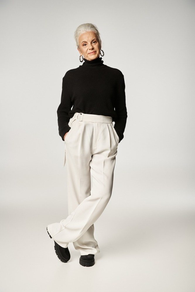 Trendy outfit for women over 70: black turtleneck + white wide-leg