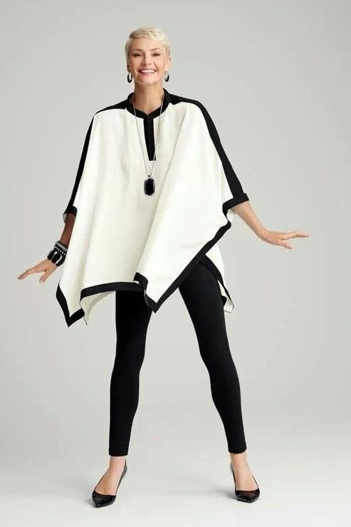 Trendy outfit for women over 70: black-and-white poncho + black leggings