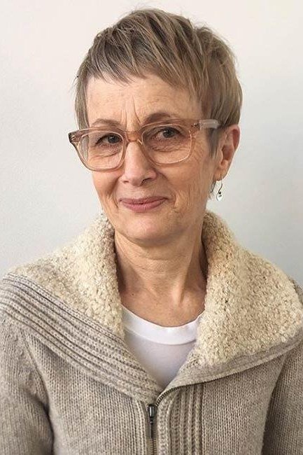 Brown pixie with beige glasses, front view - pixie haircut for women over 60