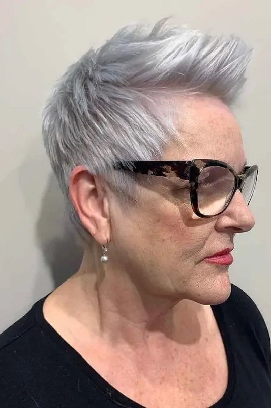 Silver swept pixie haircut with glasses for older women, side view
