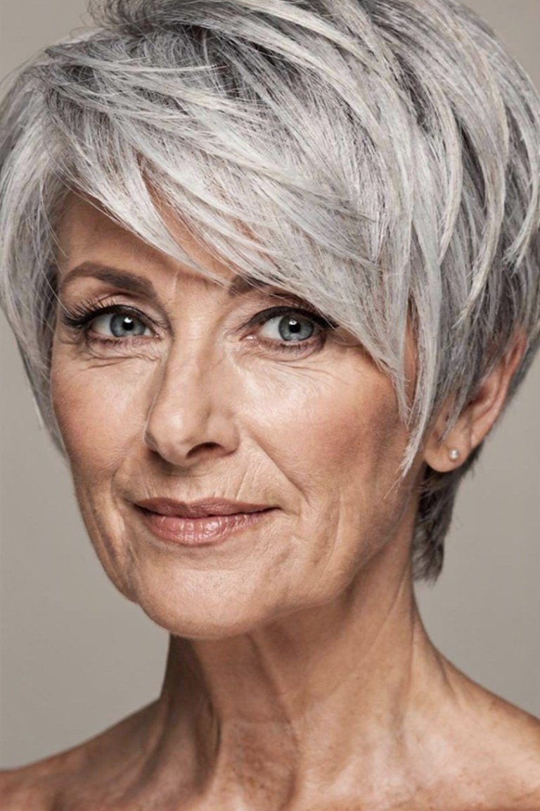 Silver pixie haircut with soft wispy bangs for women over 60, front view