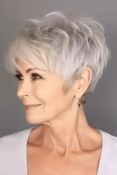 Classic silver pixie haircut with neat bangs for older women