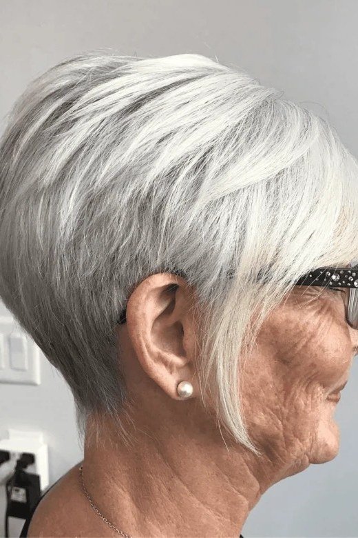 White pixie haircut with simple side bangs, profile view, for women over 60