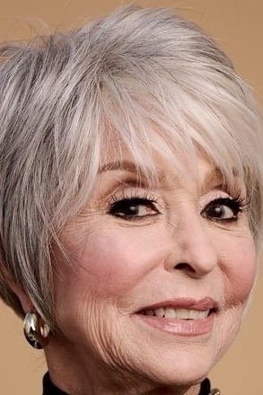 Silver pixie haircut with bold full fringe for women over 60, front view