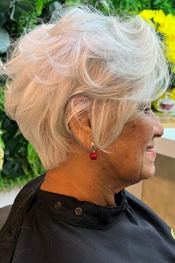 White pixie haircut with wavy side bangs, profile view, for women over 60