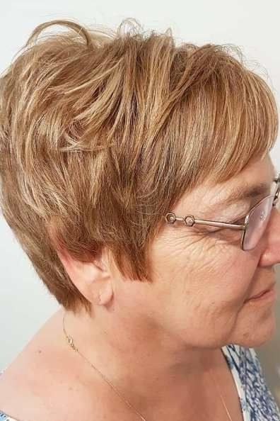 Copper pixie haircut with bangs for women over 60, profile view