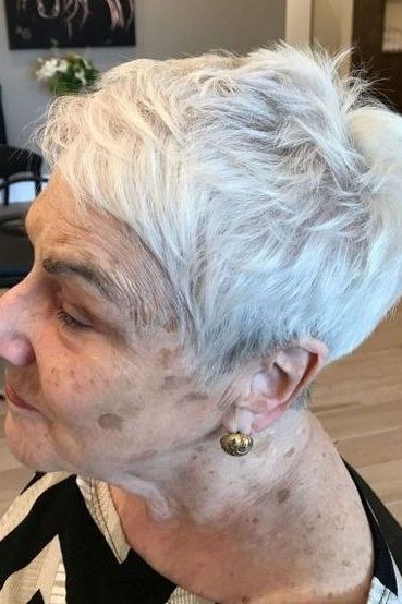 White pixie haircut with soft bangs, side view, for women over 60