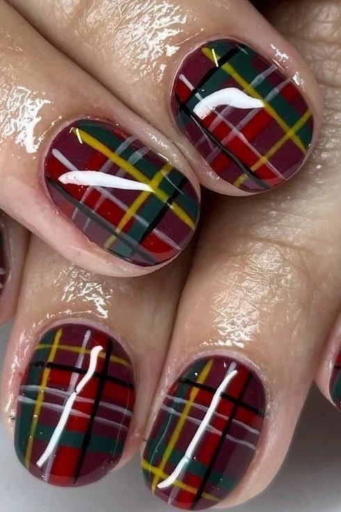 Bold red green and yellow tartan plaid nail design on round nails
