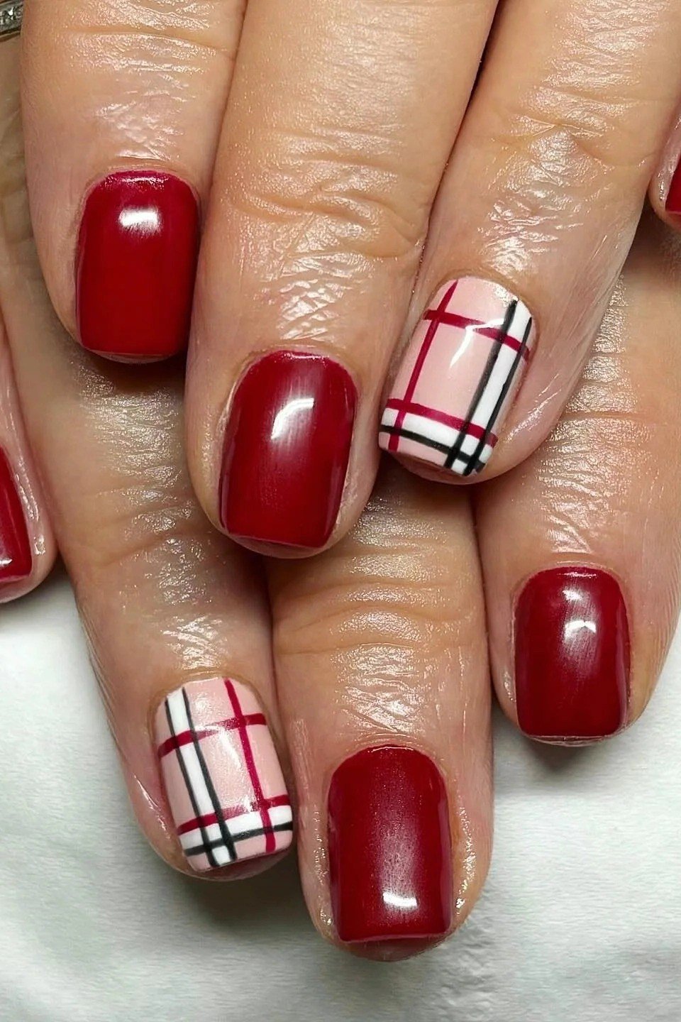 Apple red nails with white and red plaid accent nails