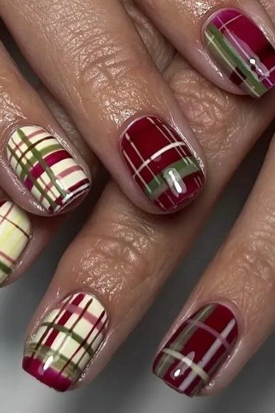 Burgundy and olive green plaid nail design on almond nails