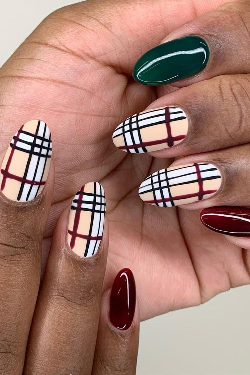 Emerald green and oxblood plaid almond nails