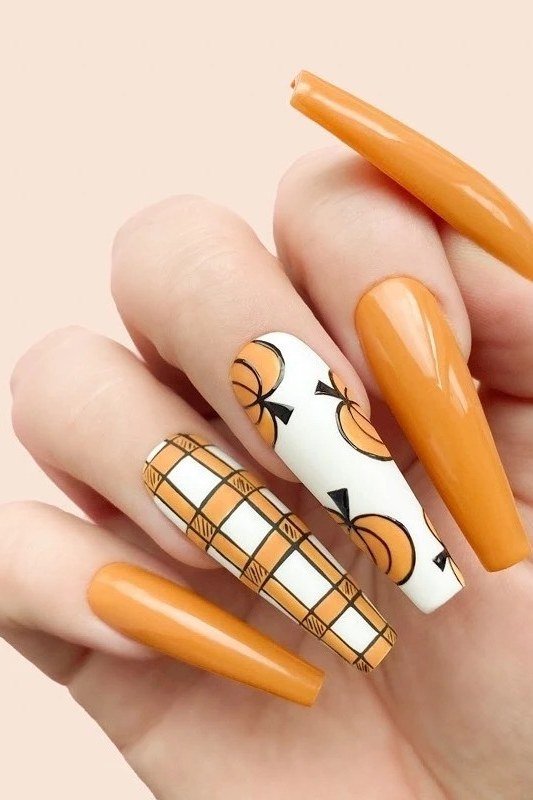 Orange nails with pumpkin art and gingham on long coffin nails