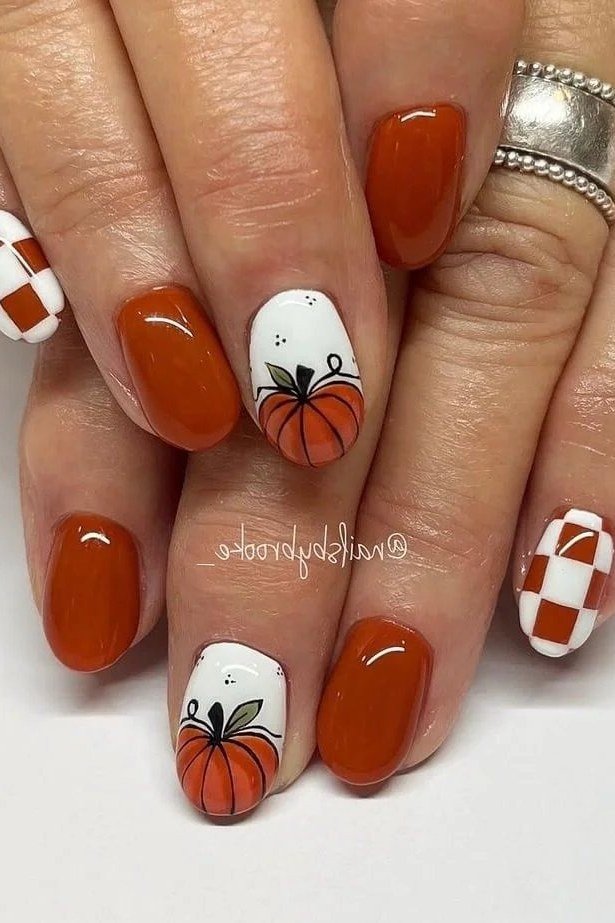Burnt orange nails with pumpkin and gingham nail art