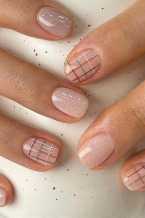 Sheer nude nails with subtle brown grid plaid