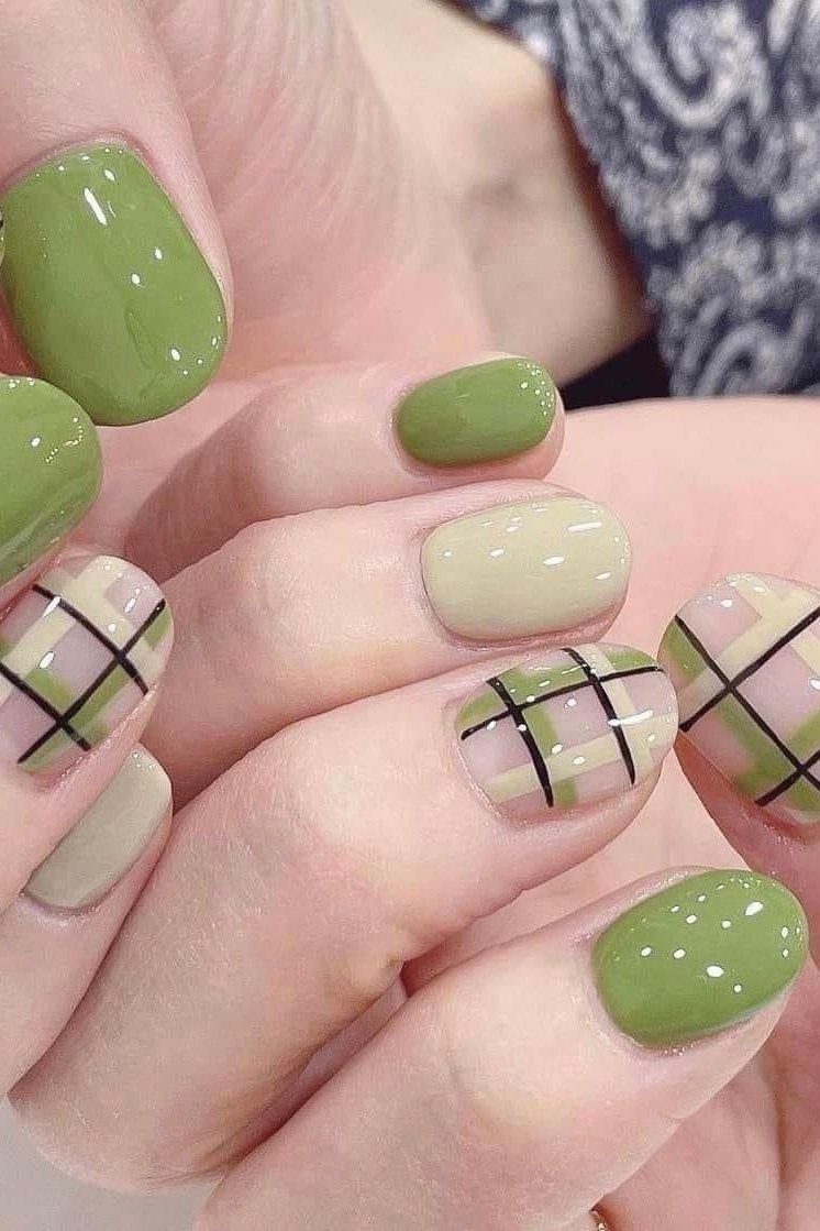 Sage green nails with green and black plaid accents