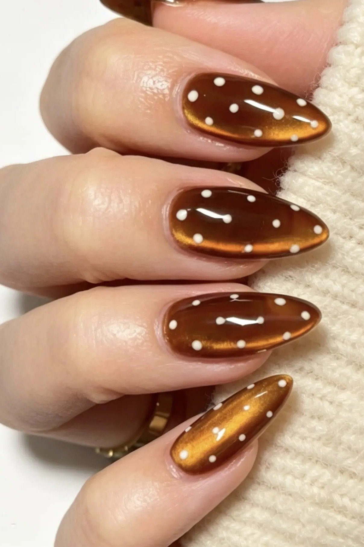 Caramel cat-eye almond nails with white polka dots, fall nails for women over 50