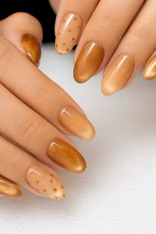 Caramel to champagne gradient almond nails with white polka dots, fall cat-eye nails