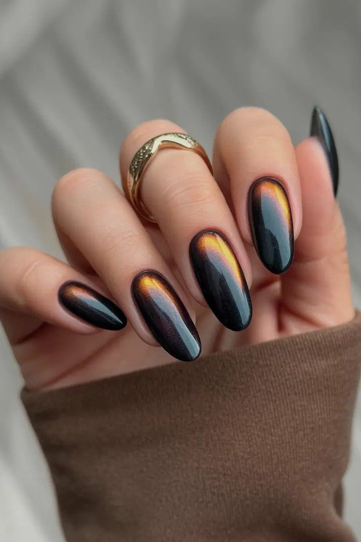 Oil slick rainbow cat-eye almond nails with white polka dots, unique fall nail art