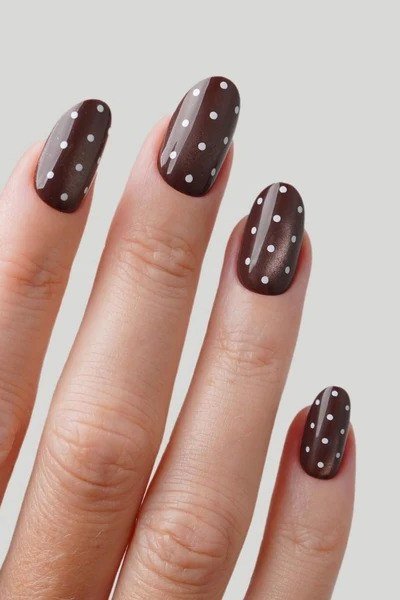 Burgundy almond nails with white polka dots front view, classic fall nail design